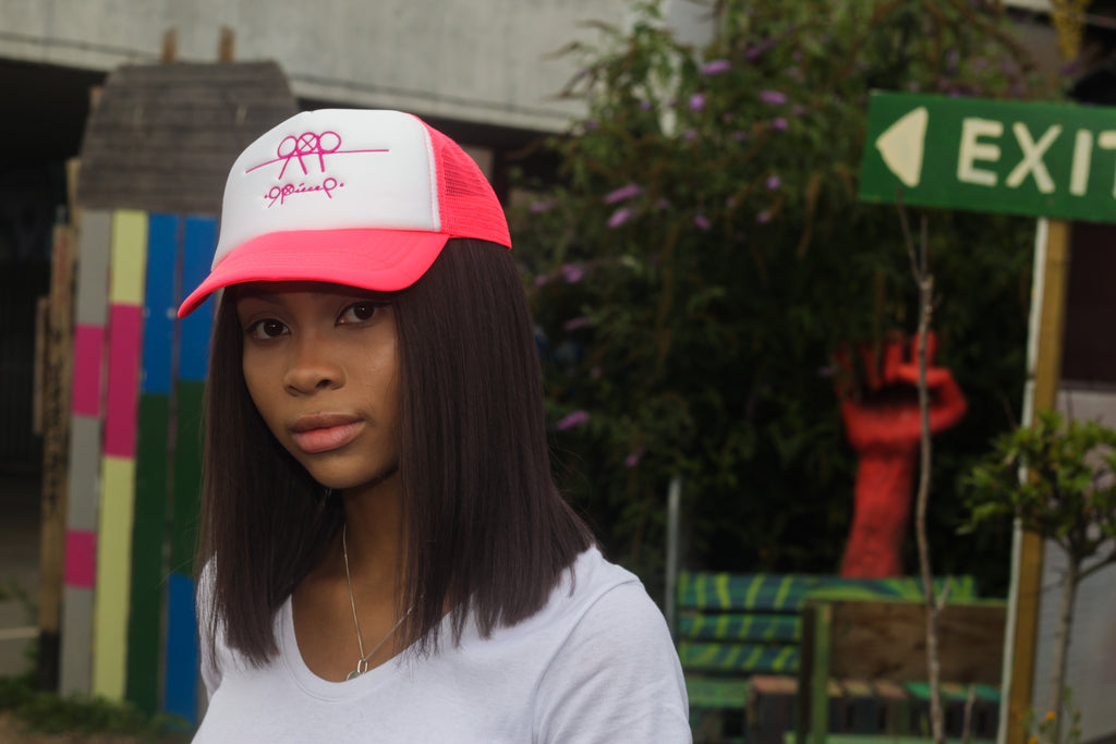 99Piece White & Pink Trucker Cap with adjustable snap.  100% Cotton (front panel and peak) & 100% Nylon mesh rear panels.