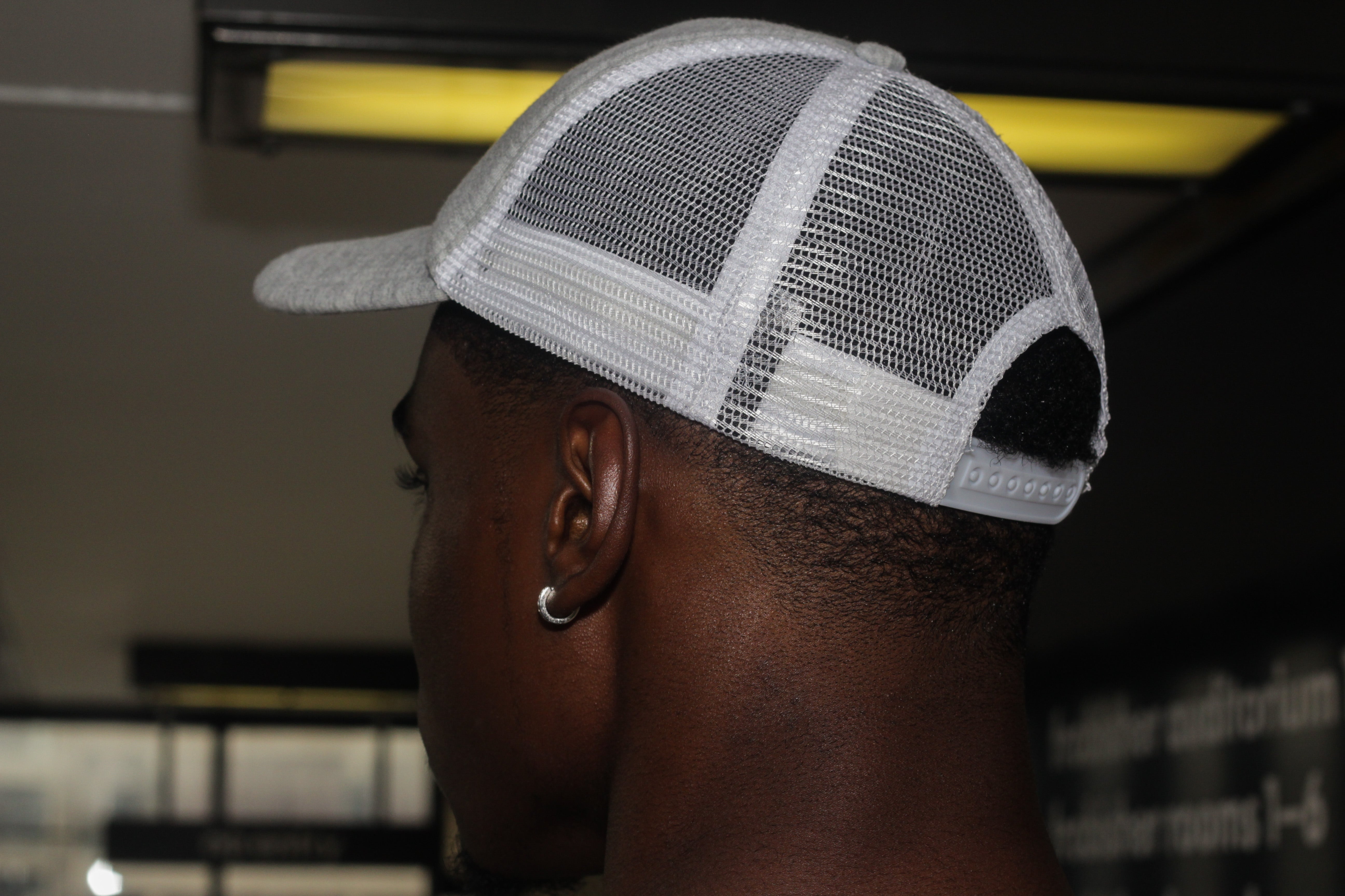 99Piece Grey and White Trucker Cap with adjustable snap.  100% Cotton (front panel and peak) & 100% Nylon mesh rear panels.